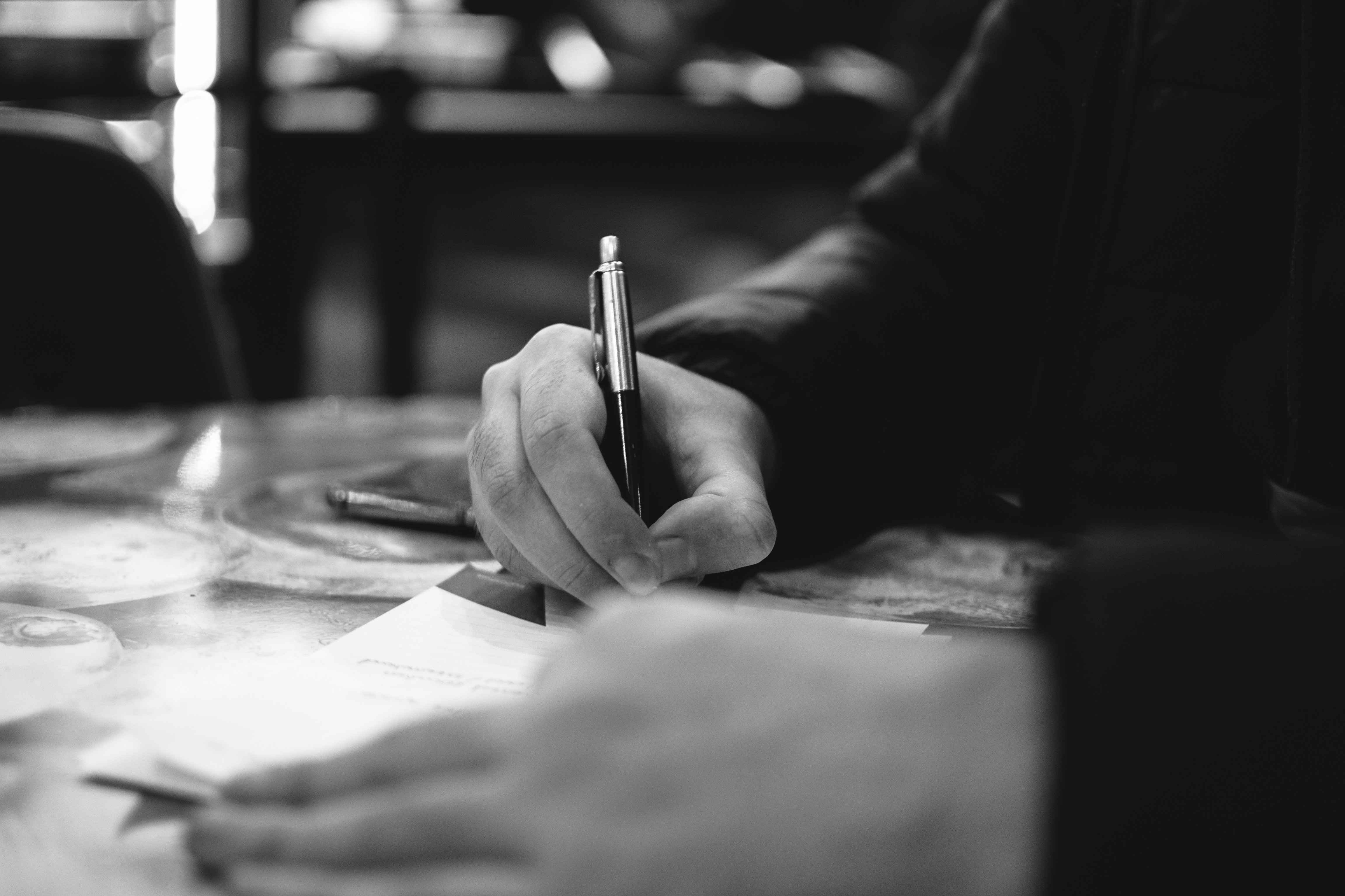 Stock photo of pen and paper. Photo by Owen Michael Grechon on Unsplash.